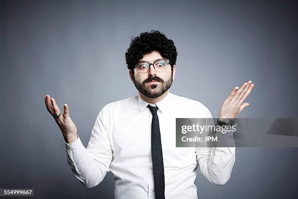 portrait of young man, hands open in questioning expression - man asking stock pictures, royalty-free photos & images