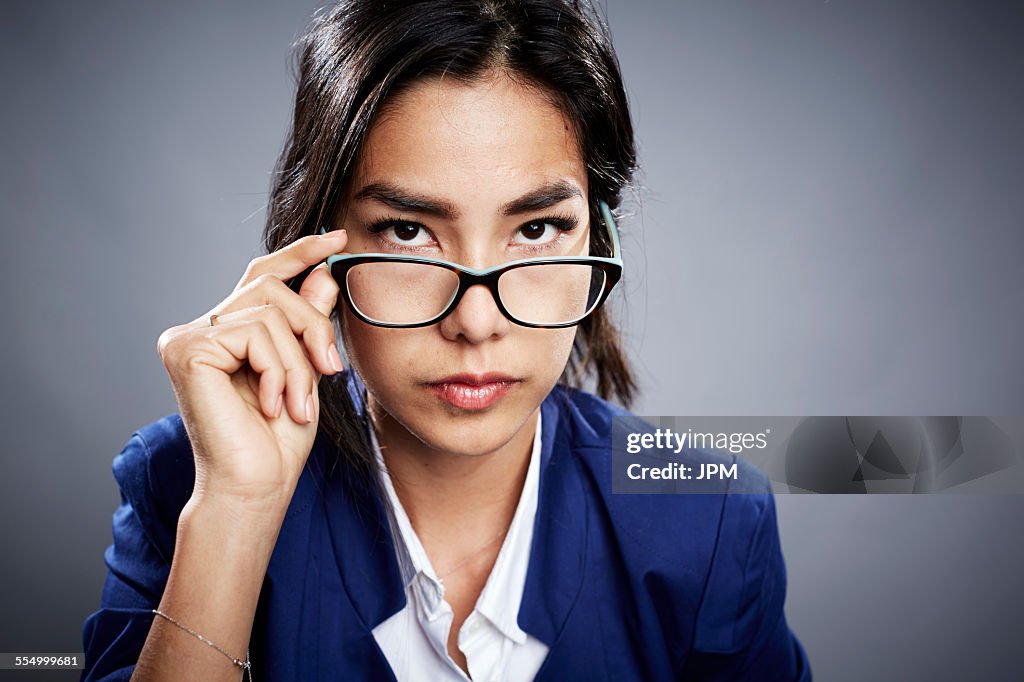 Look Over Spectacles Portrait Of Young Woman Looking Over Eyeglasses High-Res Stock Photo ...