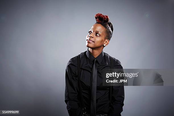 Portrait of young woman, looking up, smiling