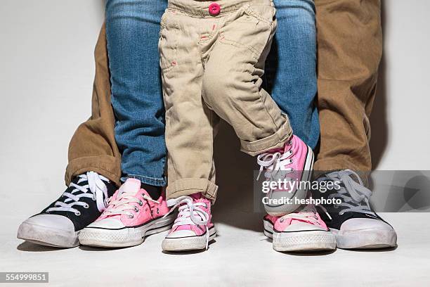 feet and legs of family with toddler daughter - family shoes fotografías e imágenes de stock