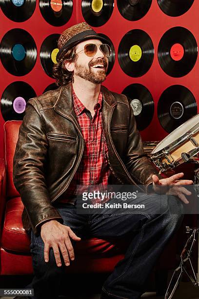 portrait of musician, vinyl records on background wall - trophy wall stock pictures, royalty-free photos & images