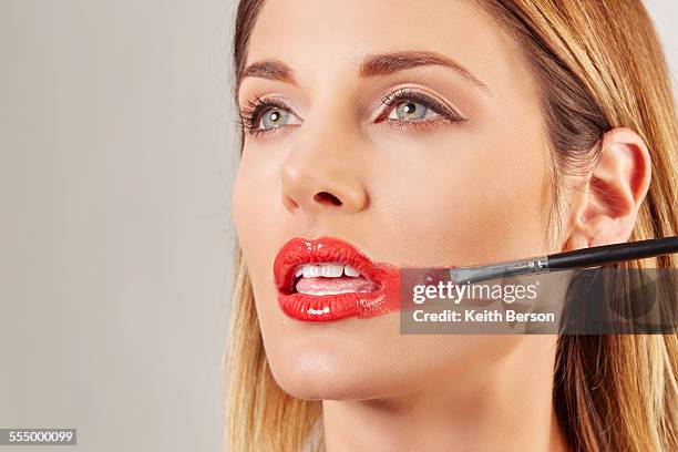 woman applying lipstick badly - mistake foto e immagini stock