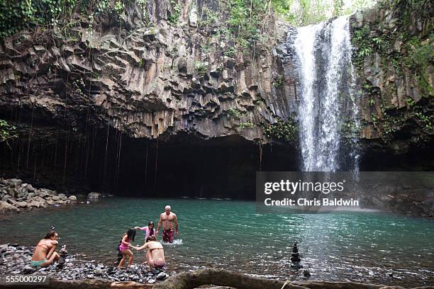people swimming by waterfall - water fall hawaii 個照片及圖片檔
