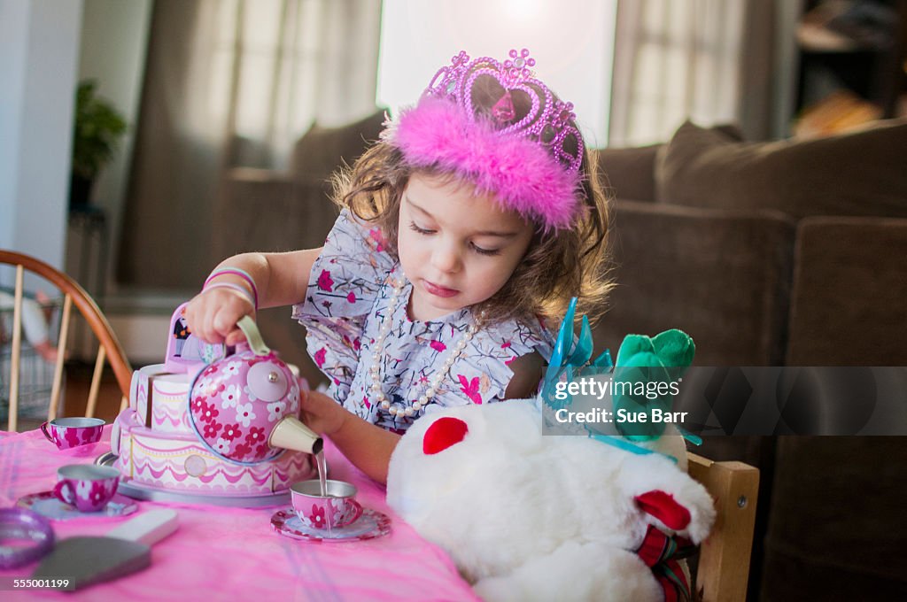 Female toddler wearing princess crown at birthday party