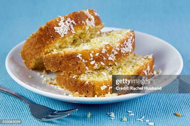 sliced home made coconut cake on plate - coconut cream stock pictures, royalty-free photos & images