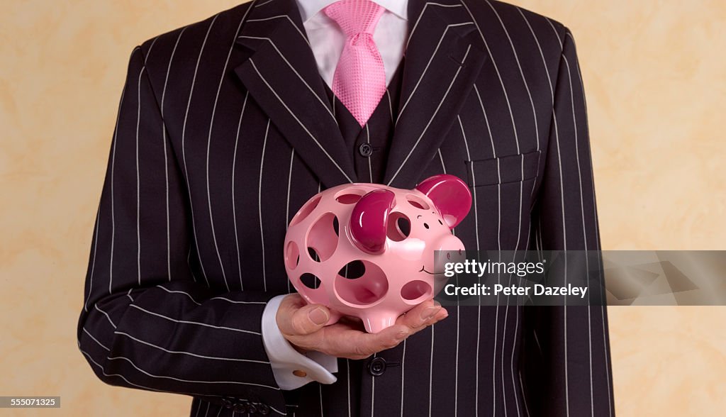 Banker/financial advisor with holey piggy bank
