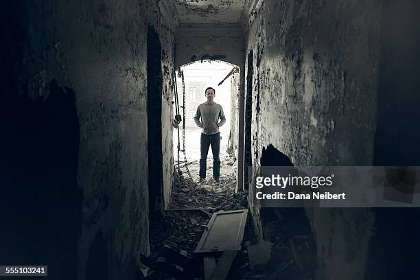 man standing in abandoned building - detroit ruins stock pictures, royalty-free photos & images