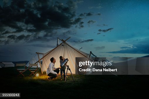 Father and son looking through telescope Father and son looking through telescope