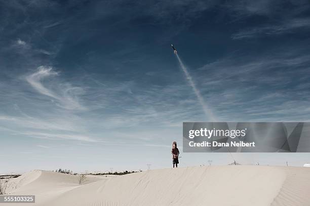 boy launching model hobby rocket in desert - model rocket stock pictures, royalty-free photos & images