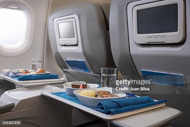 airline meals served on seat tables - first class plane stock pictures, royalty-free photos & images