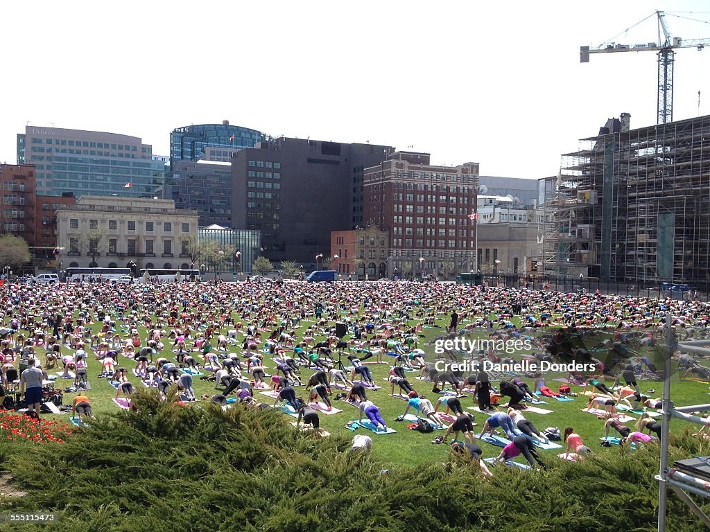 Huge group practicing yoga on Parliament Hill