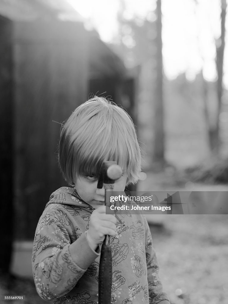 Boy holding hammer