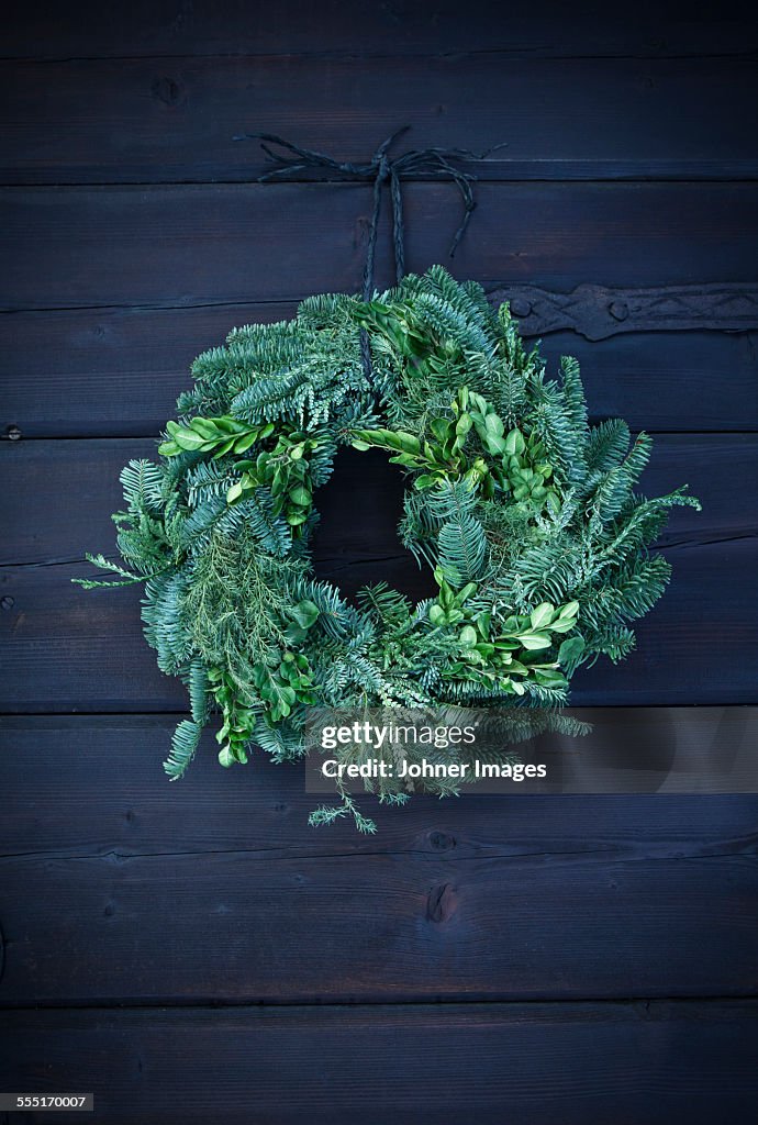 Wreath hanging on wooden wall