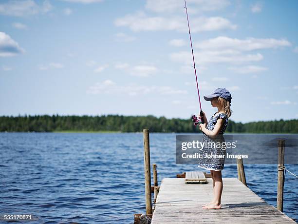 girl fishing on jetty - freshwater fishing stock photos et images de collection