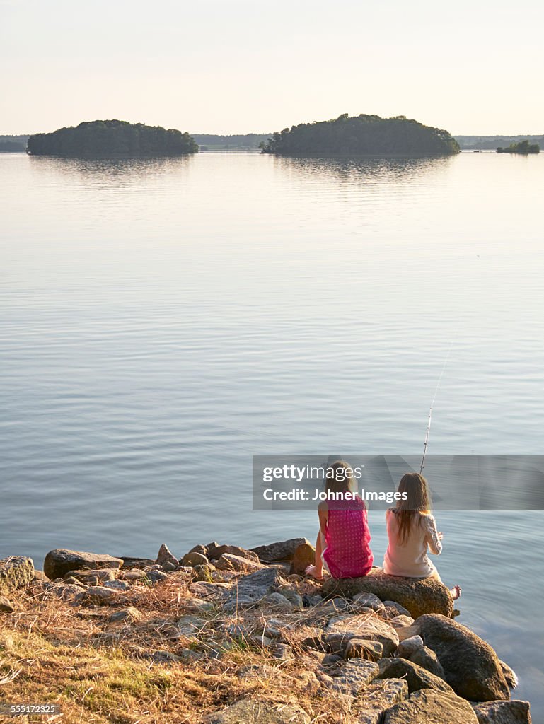 Girls fishing at lake