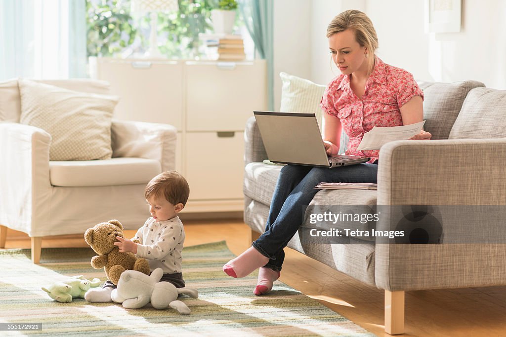 Working mother and son (2-3 years) in living room