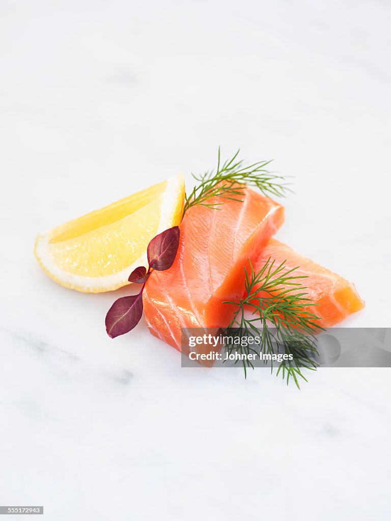 Salmon and lemon on white background