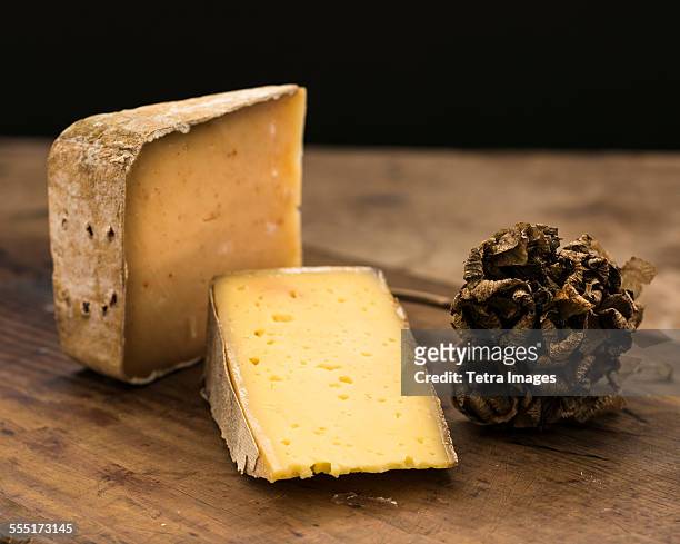 hard cheese slices and truffle on wooden table, studio shot - hartkäse stock-fotos und bilder