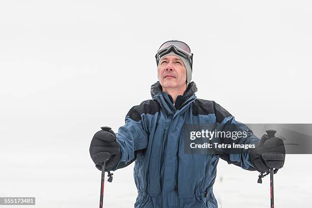 portrait of mature male skier - ski poles stock pictures, royalty-free photos & images