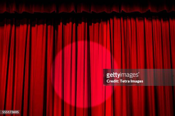 spotlight on red curtain - red curtain stockfoto's en -beelden