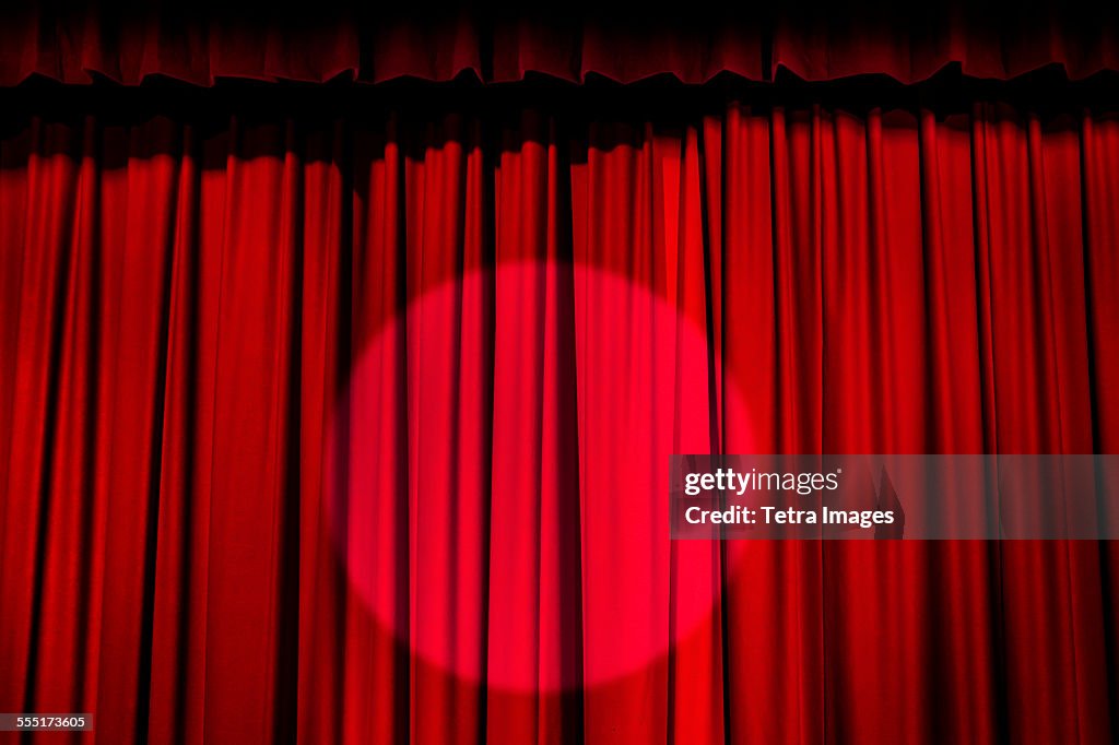 Spotlight on red curtain