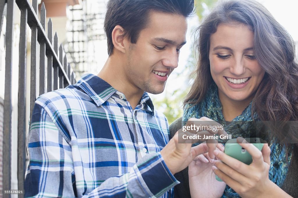 USA, New York State, New York City, Brooklyn, Young couple texting 