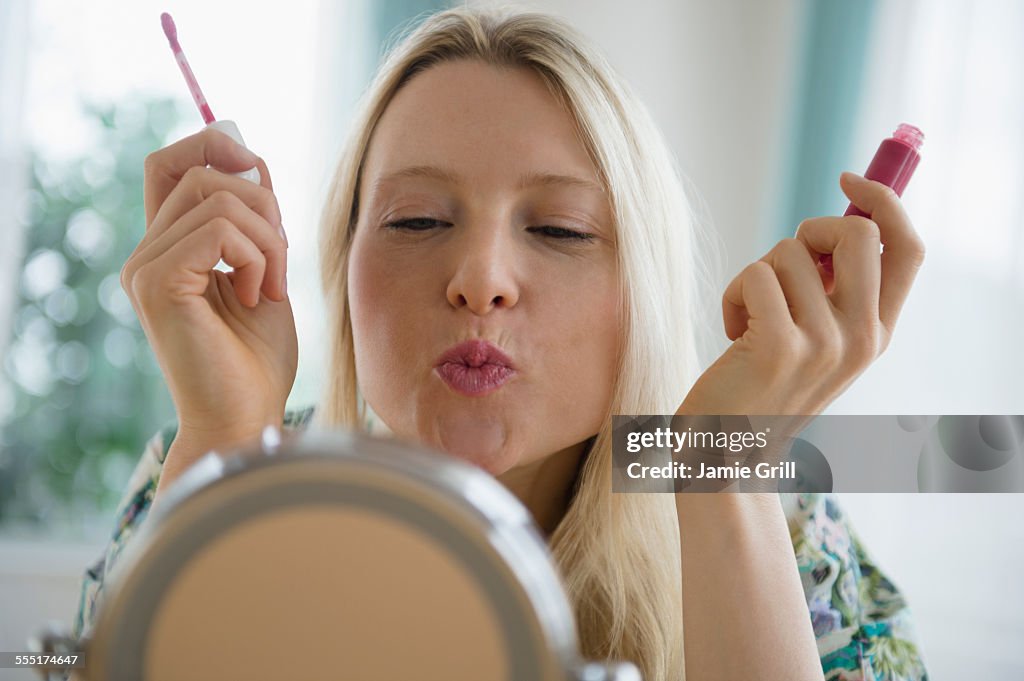 Jersey City, Woman applying lipgloss