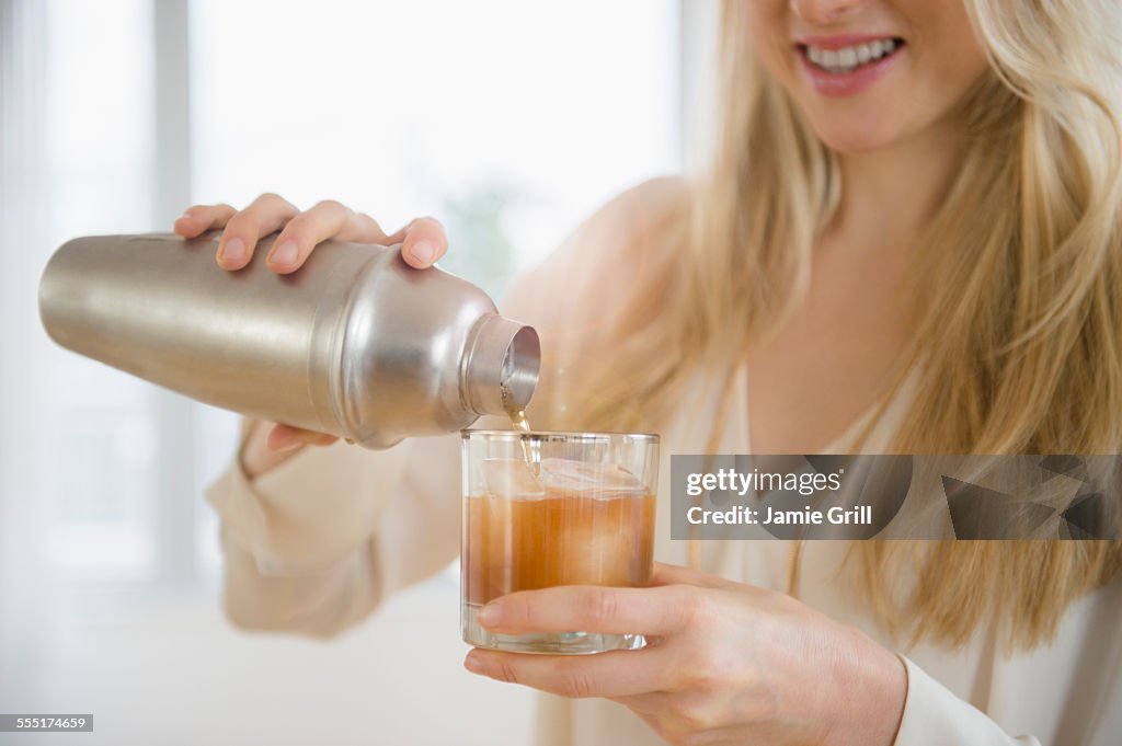 Jersey City, Woman pouring cocktail into glass