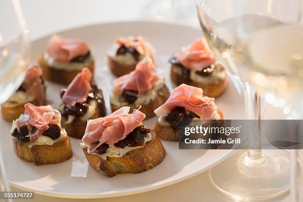 studio shot of canapes on plate - grill party stockfoto's en -beelden