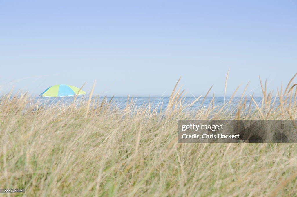 USA, Massachusetts, Nantucket Island, Siasconset Beach, View of beach umbrella by sea