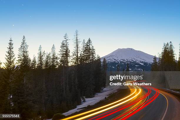 usa, oregon, mount bachelor, view of light trail on road in forest - mt bachelor stock pictures, royalty-free photos & images