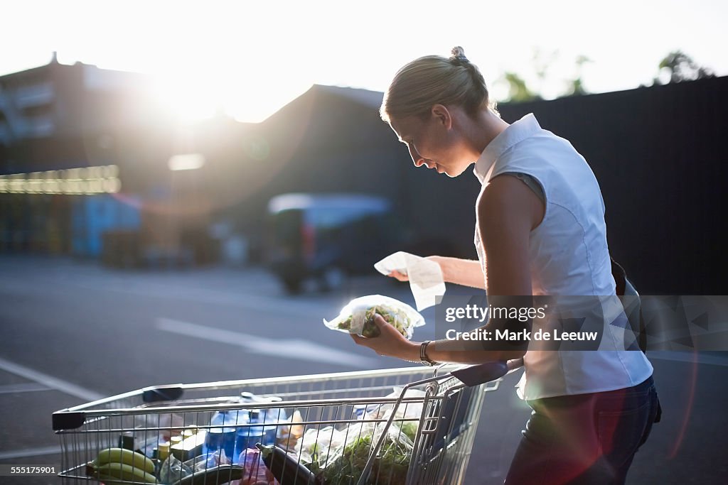 Netherlands, Tilburg, Woman checking shopping