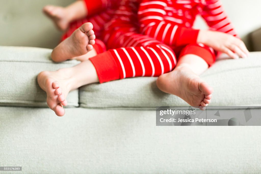 USA, Utah, Salt Lake City, Feet of siblings (2-3, 4-5) in red pajamas