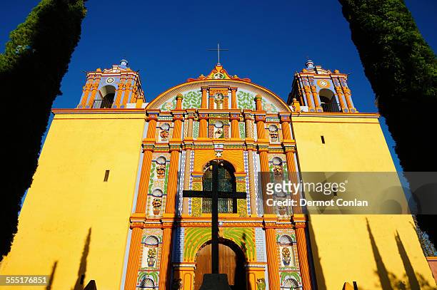 mexico, oaxaca, santa ana zegache, low angle view of yellow ornate church - oaxaca stock pictures, royalty-free photos & images