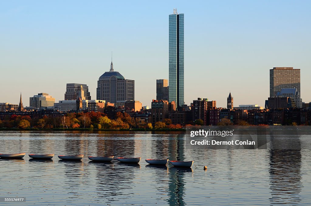 USA, Massachusetts, Boston, Charles River, Row of boats on river, waterfront in background
