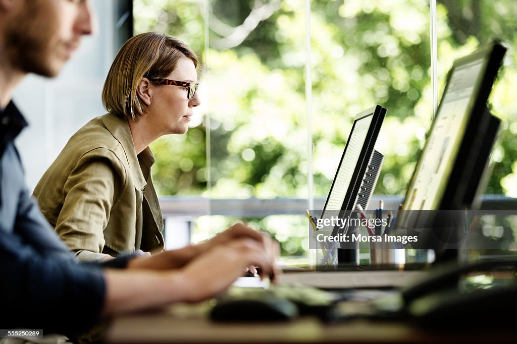 Businesswoman using computer in office