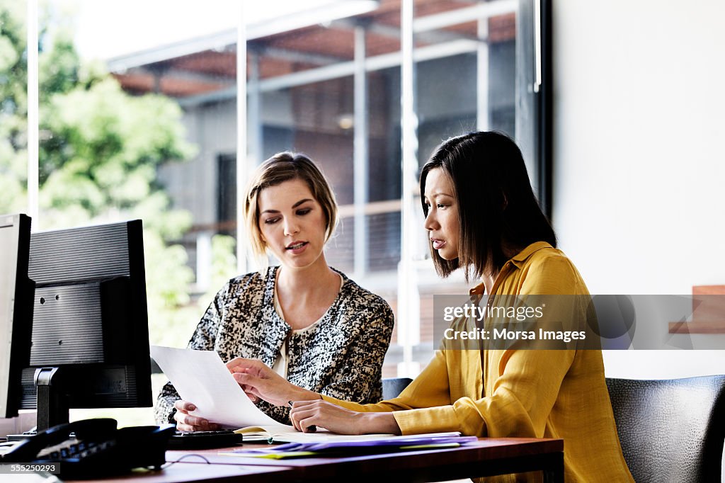 To Discuss Over Businesswomen Discussing Over Document High-Res Stock Photo - Getty Images