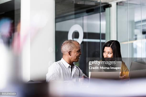 business people discussing in office - business person at desk stock pictures, royalty-free photos & images