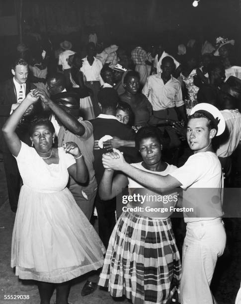 British sailor joins Jamaicans at a dance in Kingston to celebrate after independence was granted to Jamaica, 6th August 1962. The island was...