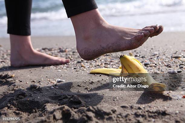 foot over banana skin - banana skin stock-fotos und bilder