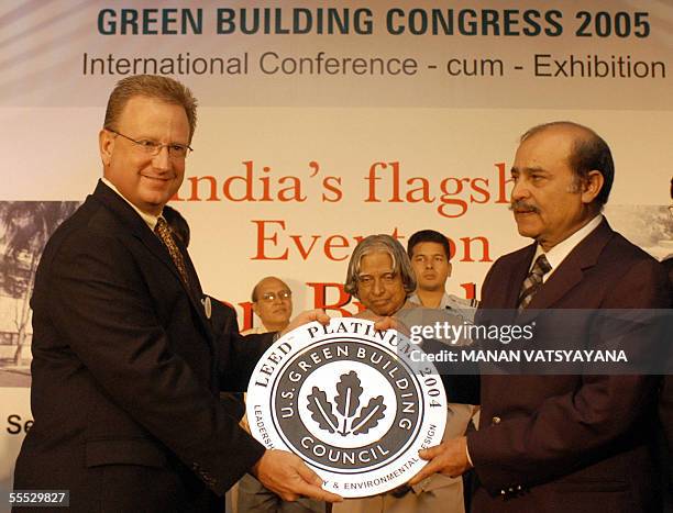 Former chairman of the US Green Building Council, James.E.Hartzfeld presents the Platinum Green Building Award to ITC Green centre Director...