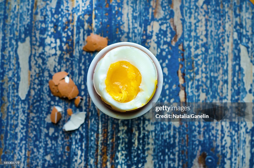 Boiled egg on a wooden table.