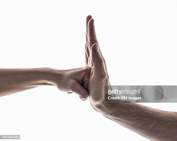 fist into palm - relationship conflict stock pictures, royalty-free photos & images