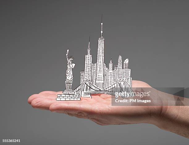 new york city in man's hand - statue of liberty drawing stock pictures, royalty-free photos & images