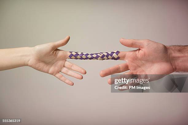 chinese finger trap - couple trapped stock pictures, royalty-free photos & images