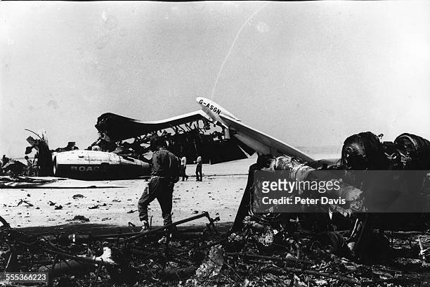 Uniformed men examine the wreckage of exploded passenger planes at Dawson's Field, Zarqa, Jordan, early September, 1970. The planes had been...
