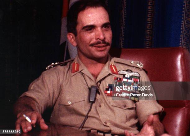 Portrait of King Hussein of Jordan , dressed in a military uniform and with a cigarette in his right hand, 1970.