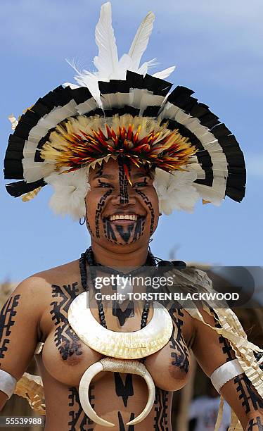 Motu Koitabu girl from the Gulf of Papua wears a kina shell and wild boar tusks as she comes ashore on Ela Beach during the Hiri Moale festival in...