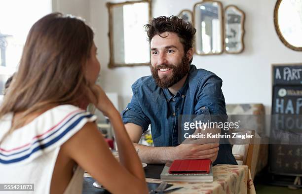 couple in a café, talking to each other - selective focus imagens e fotografias de stock