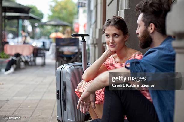 couple waiting at the doorstep with suitcase - buenos aires travel stock pictures, royalty-free photos & images